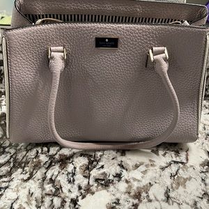 Kate spade all leather Handbag with black and white pinstripe lining.